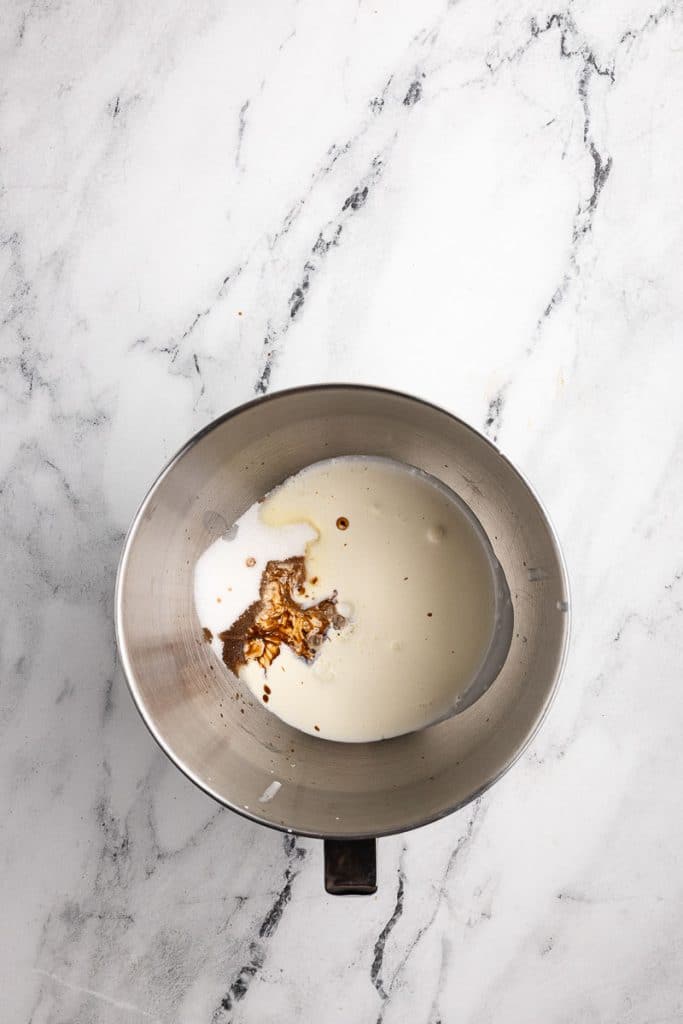 Whipping cream, vanilla and sugar in a bowl.