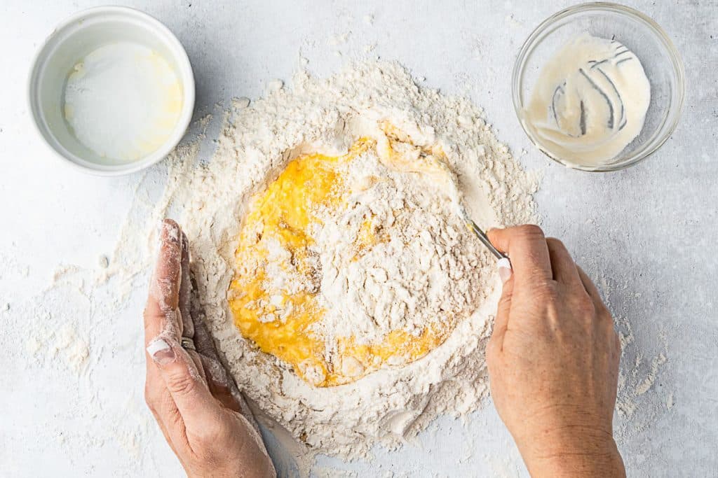 start incorporating flour into egg oil mixture.