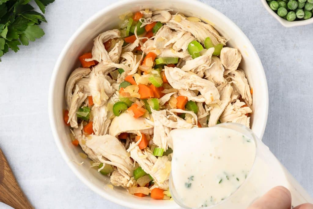 Pour sauce into vegs and chicken in casserole.