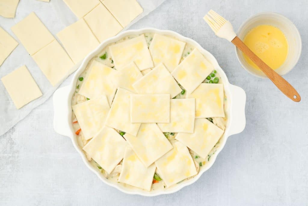 Covered with puff pastry squares.