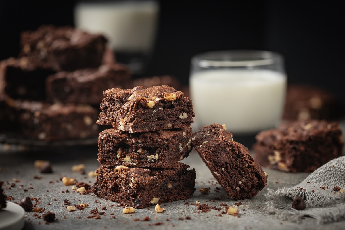 Chocolate chocolate chip cookie bar and a glass of milk.