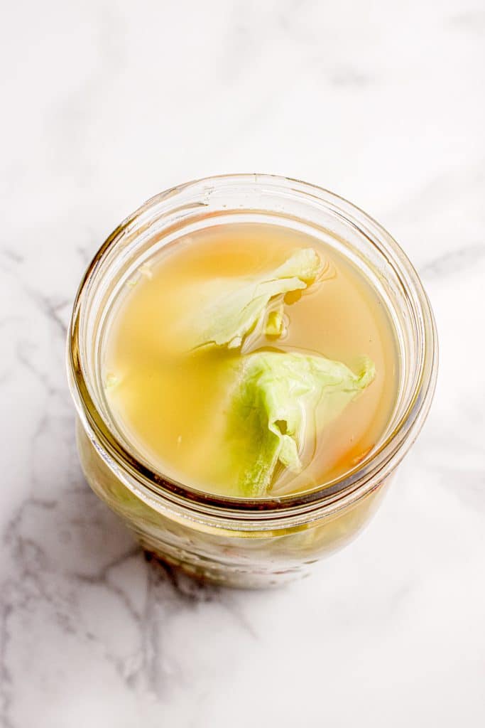 Cabbage leaves on top of jar.