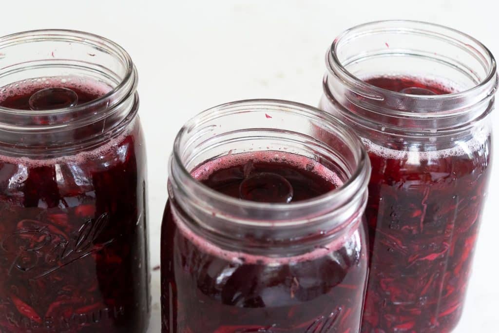 Jars of beet and cabbage sauerkraut.