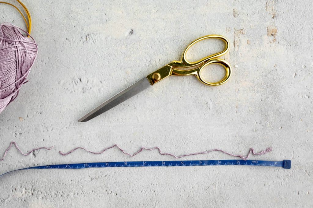 Cutting yarn for fringe.