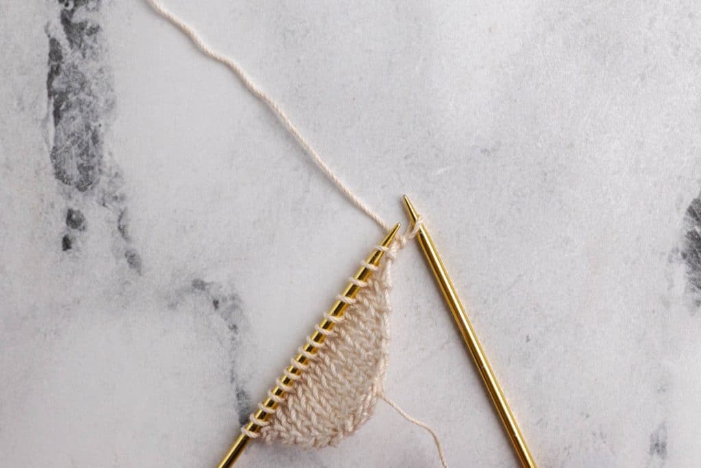Showing how to do eyelet increases on the sides.