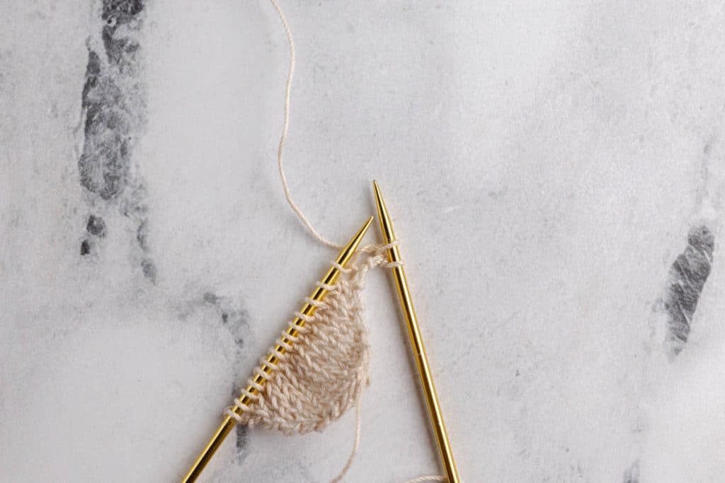 Showing how to do eyelet increases on the sides.
