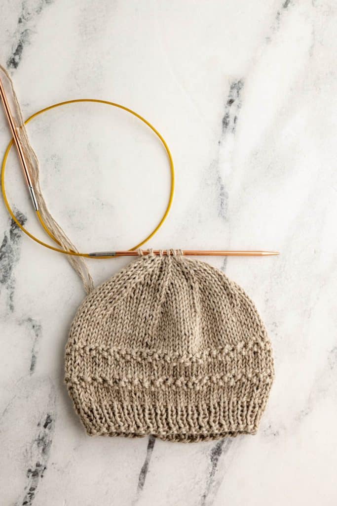 Baby Hat knit in taupe yarn.