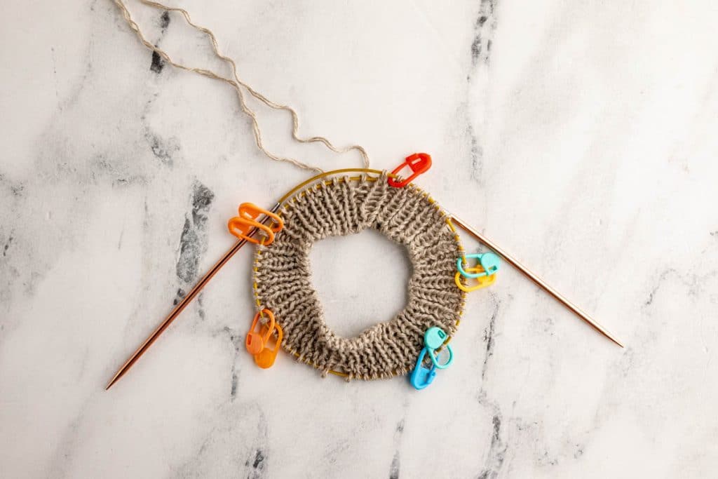 Knitting the neck of the baby sweater.