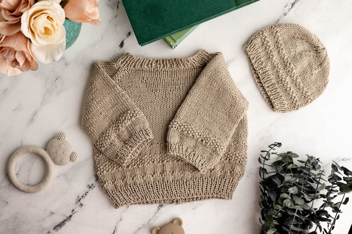 Knit baby sweater and hat.