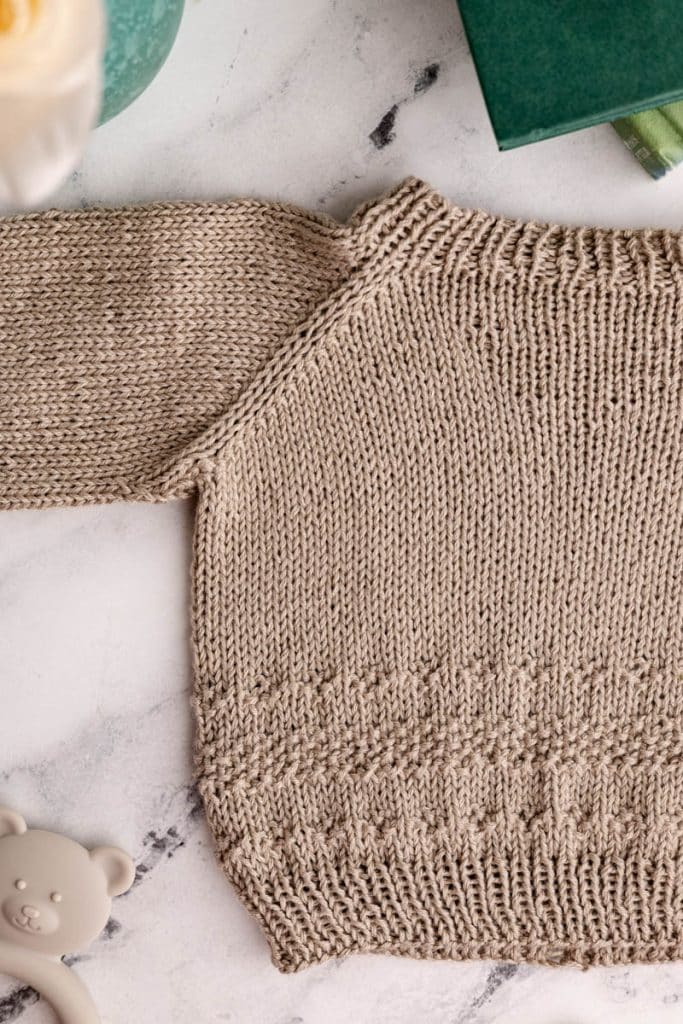 Baby Sweater knit in taupe yarn.