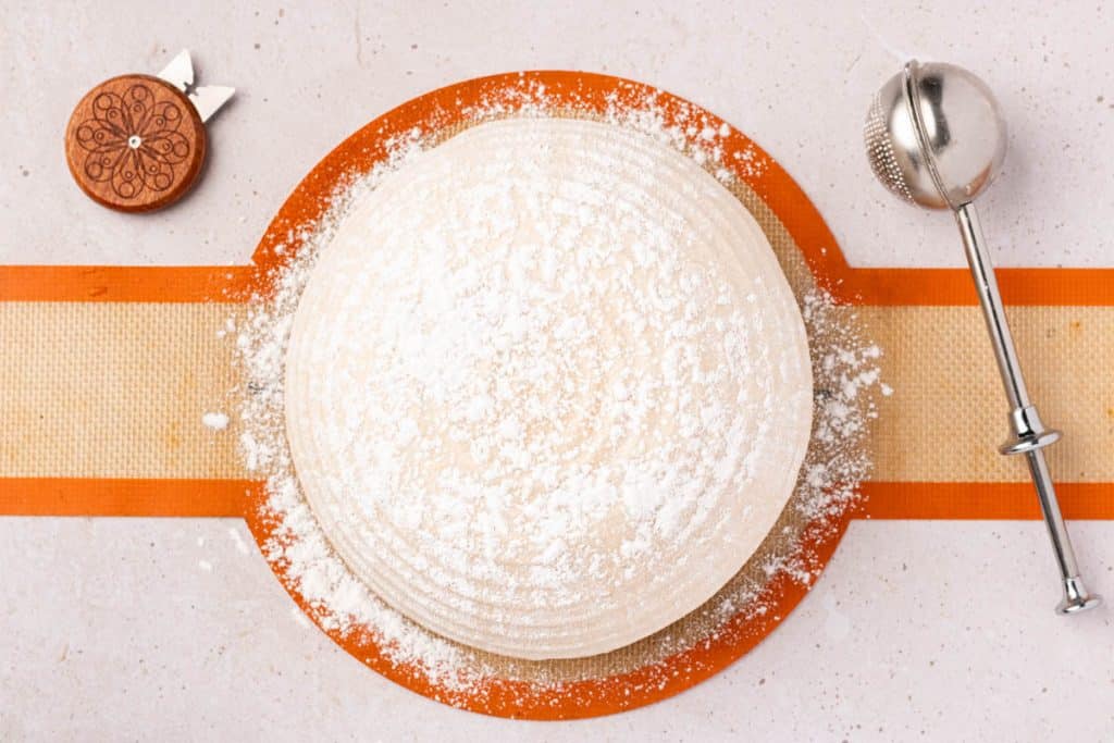 Rice flour over dough.