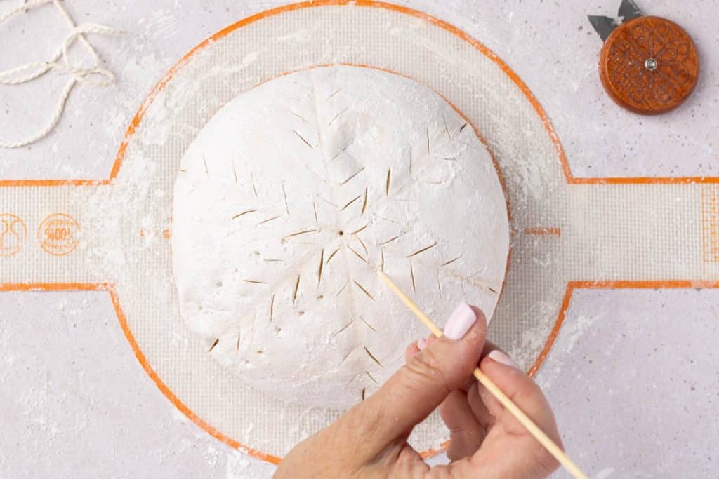 poking holes with skewer.
