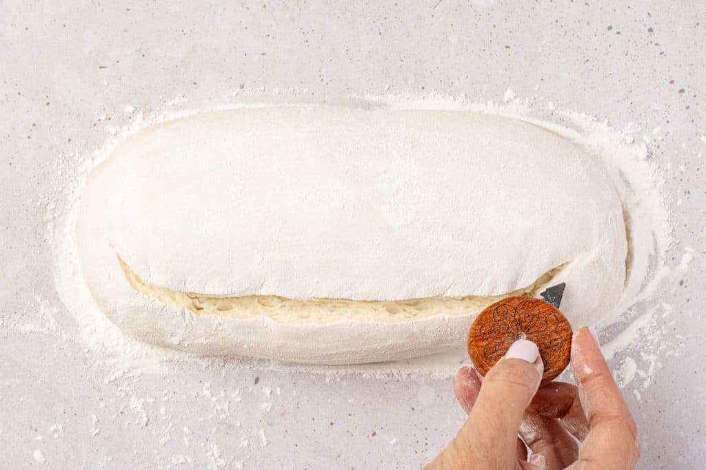 Cutting dough with lame.