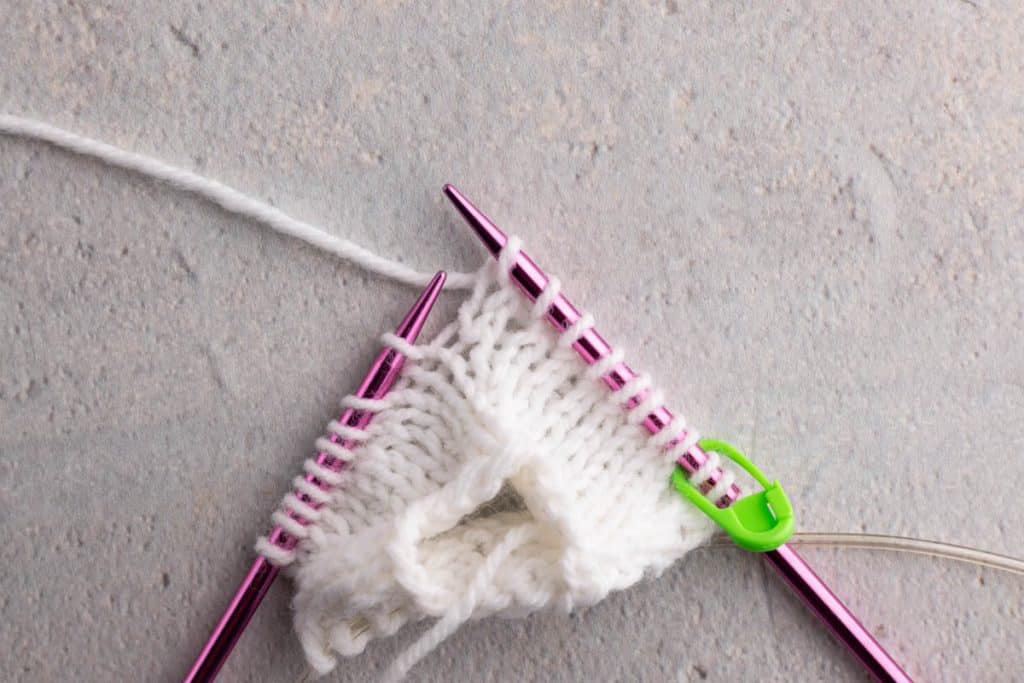Showing how to lift a stitch.
