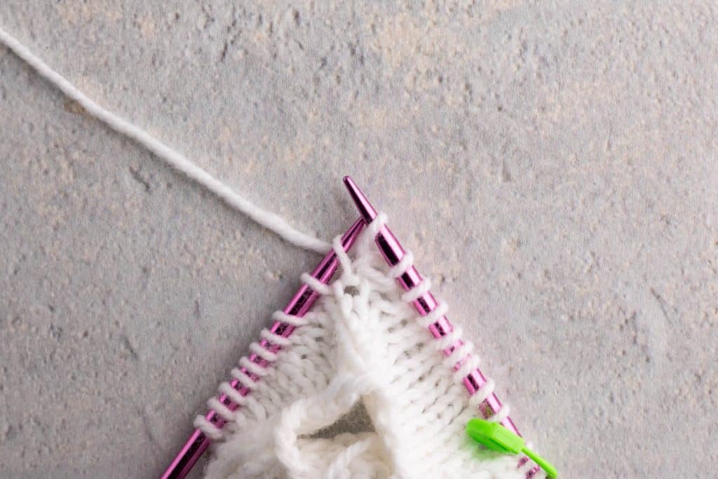 Showing how to lift a stitch.
