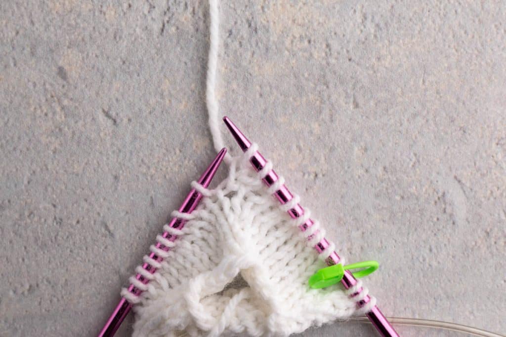Showing how to lift a stitch.