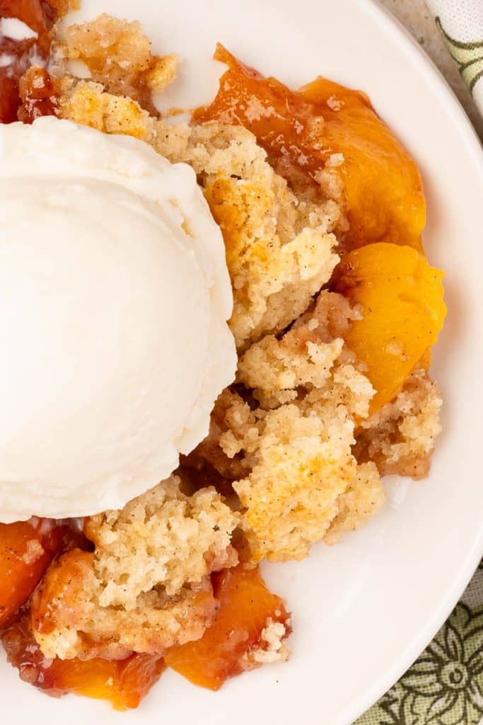Peach cobbler with ice cream.