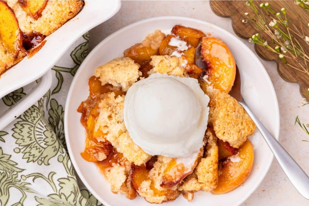 Peach cobbler with ice cream.
