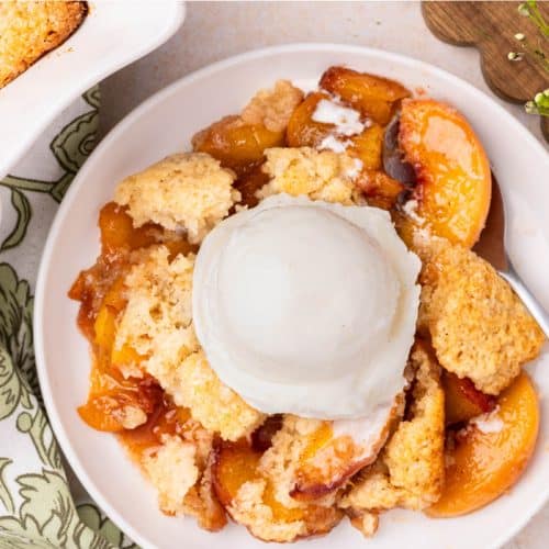 Peach cobbler with ice cream.