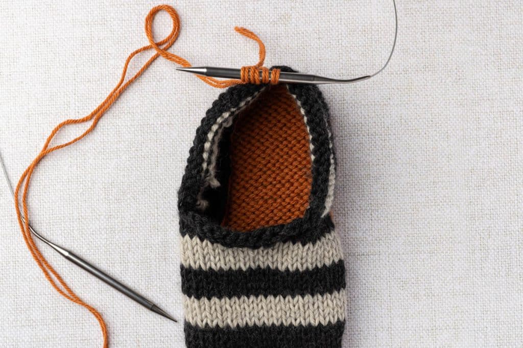 Knitting icord around slippers.