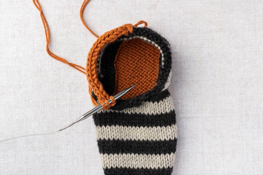 Knitting icord around slippers.