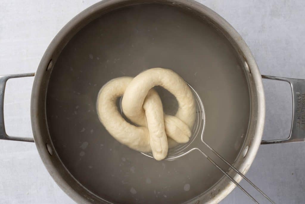 Boiling pretzel.